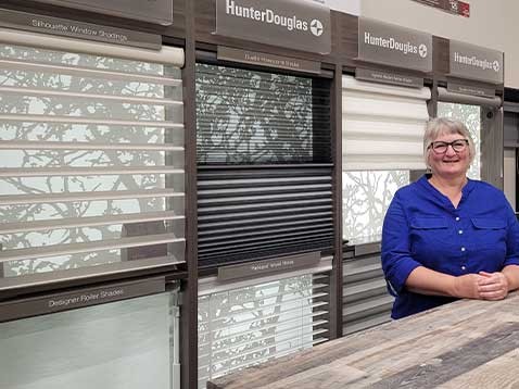 Smiling woman posing for a photo in the showroom